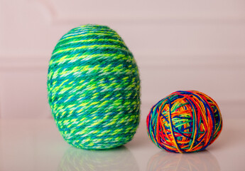 Handmade woolen Easter eggs in vibrant green and multicolored hues, ideal for seasonal home decor.