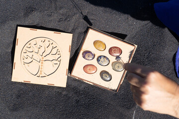 Healing crystals on black sand background