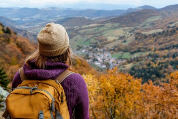 A trendy female traveler with a felt hat and brown backpack is posed in front of the picturesque mountains and Uzungol Lake in Trabzon during her Turkish adventure