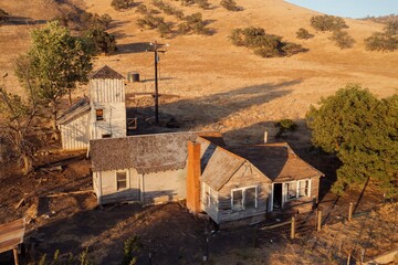 An aerial view shows an abandoned farm house and water tower in a rural setting in White River,...