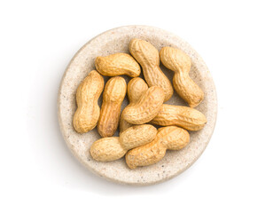 plate of peanuts in shell on white background