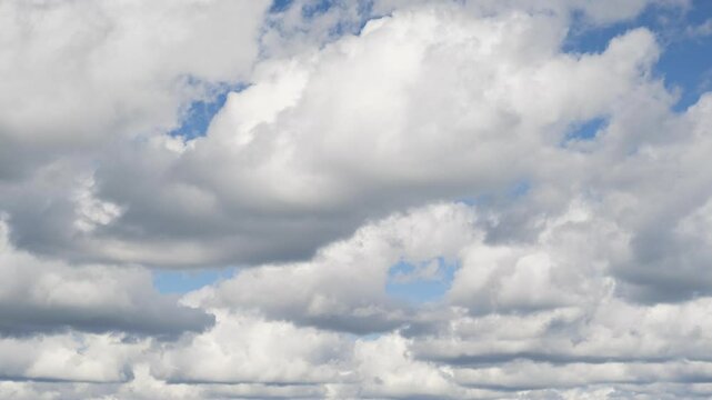 Rolling moving clouds timelapse for background. Pan right fast day time lapse of a cloud filled sky as clouds gather