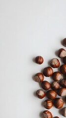 Nutty Delight: A close-up, overhead shot of a pile of hazelnuts against a simple backdrop, highlighting their rich color, textures, and organic shapes.
