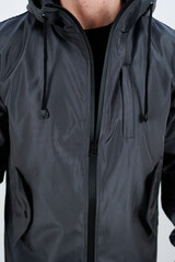 A Stylish Black Jacket that features a Hood and Zipper for added convenience and style