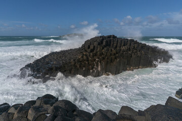 A turbulent ocean crashes into the rocks of Fingal Heads 