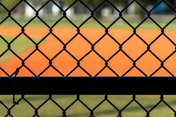 Close up chain link fence from dugout at baseball field