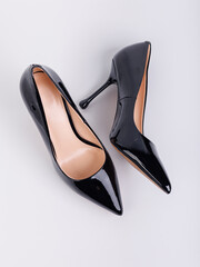 Black women's leather high-heeled pumps made of leather, isolated on a white background. Women's...