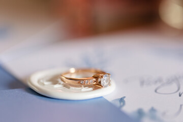 Elegant Gold Engagement Ring with Diamond Stunningly Displayed on a Stylish Background