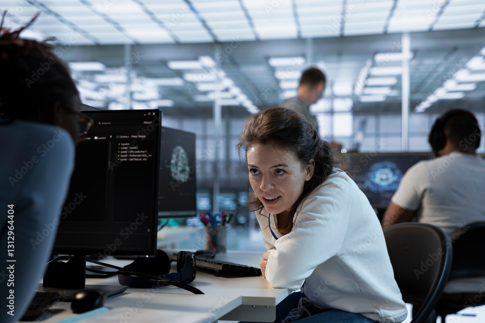Poster joyous technician chatting with colleague while doing maintenance on artificial intelligence neural 