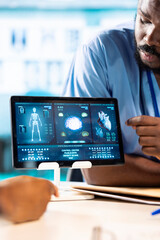 African American doctor discussing with her nurses residents to find treatment options, showcasing teamwork and professionalism in the healthcare industry. Improving the services at clinic.