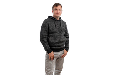 Fototapeta premium A young man wearing a gray hoodie, standing confidently with hands in pockets against a white background.