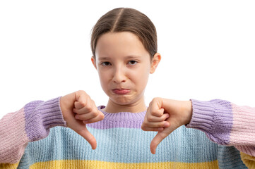 A young girl with a frown showing thumbs down against a white background.