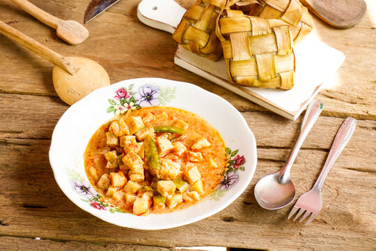 Close up of tofu rambak vegetables, potatoes with red syrup drink. Tofu vegetables are a side dish for Ketupat, a typical dish during Eid al-Fitr in Indonesia.