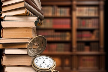 Old clock and reading book in retro library