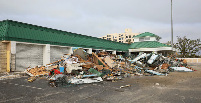 Debris from Hurricane Ian, Helene and Milton litter the outside of a building.