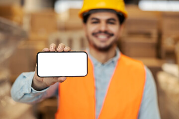 Close up of warehouse manager's hand showing phone display at camera.