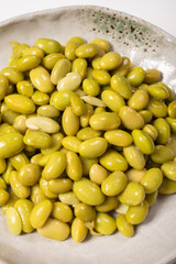 Asian vegetarian food cooked green soybeans on board