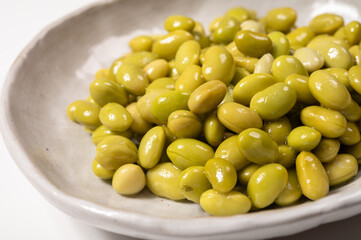 Asian vegetarian food cooked green soybeans on board