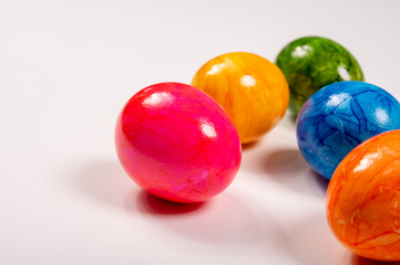 Colorful Easter eggs on table for celebration of catholic Easter in april, copy space, on white