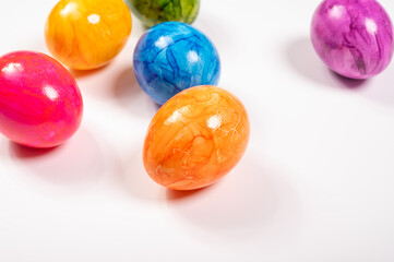 Colorful Easter eggs on table for celebration of catholic Easter in april, copy space, on white