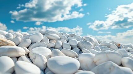 Obraz premium A rock pile of smooth white marble pebbles placed on a pastel sky blue background.