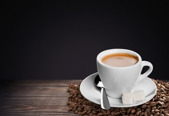 Coffee cup and aroma beans on background,