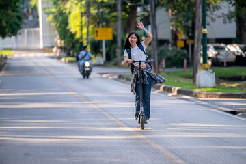 Naklejka premium A woman on a scooter is waving to people on the street