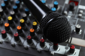 Professional mixing console with microphone, closeup. Radio studio equipment