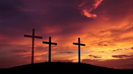 Three Crosses on a Hill Silhouetted Against a Sunset