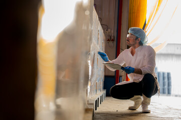 Worker monitoring packed goods in an organized warehouse Highlights of logistics inventory...