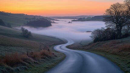 Fototapeta premium circulation fog mist Serene winding road through misty valleys.