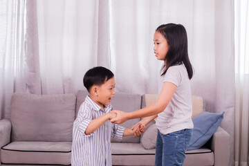 Asian sibling children play together bonding relationships on holiday at home, naughty boy kids are...