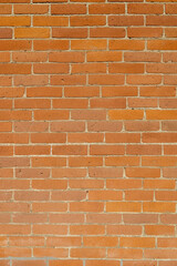 Full frame abstract texture background of a weathered old orange clay brick wall texture background