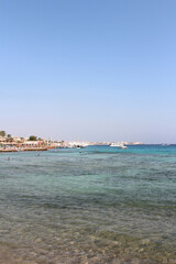 Red sea seascape with tourists swimming on a sunny day in Hurghada, Egypt