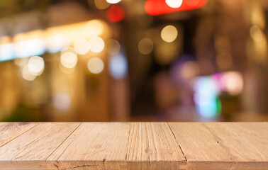 Empty wood table top and blur of restaurant background selective focus product display