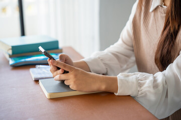 Student asian woman lying use smart phone in dorm room college mobile addict spending time checking news technology e-commerce.