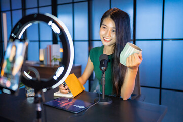 Content creator Young asian woman influencer creating content in home studio entertainment and...