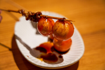 A delicious dish from a Japanese yakitori restaurant, yakitori skewers with lanterns © Steve