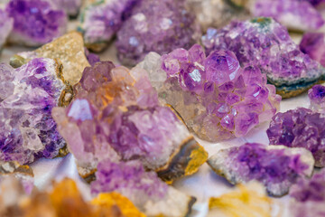 Close-up of raw amethyst crystals with vibrant purple hues, natural mineral formations, and...