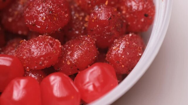 Macro of chamoy chilli gusher candy rotating on lazy susan