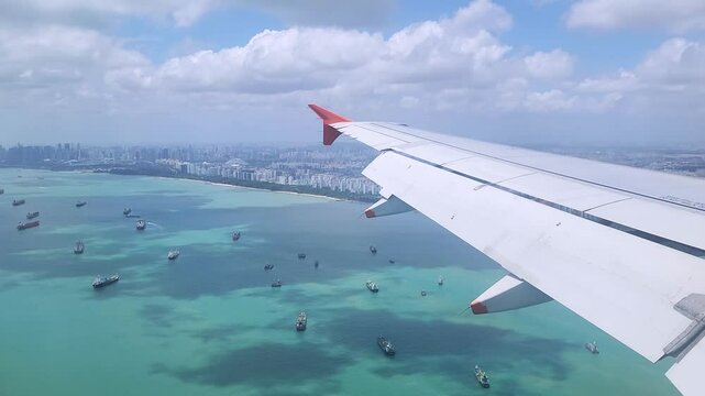 Amazing view of Singapore through the aeroplane window: the vast skyscrapers, the busy seaport, and the isolated islands.