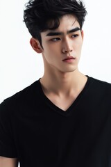 Fototapeta premium Portrait of a man with styled hair and makeup, wearing a black shirt, looking confidently at the camera.