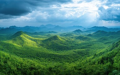 Fototapeta premium Expansive Lush Green Landscape Under Dramatic Clouds with Sunlight Breaking Through in a Serene Mountainous Environment
