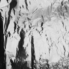 Crumpled silver aluminum foil background, abstract texture. texture on a shiny cloth. View Rustic...