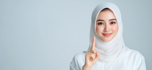 Woman in Hijab Pointing Upward