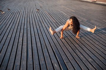 woman doing gymnastics yoga asana outdoors