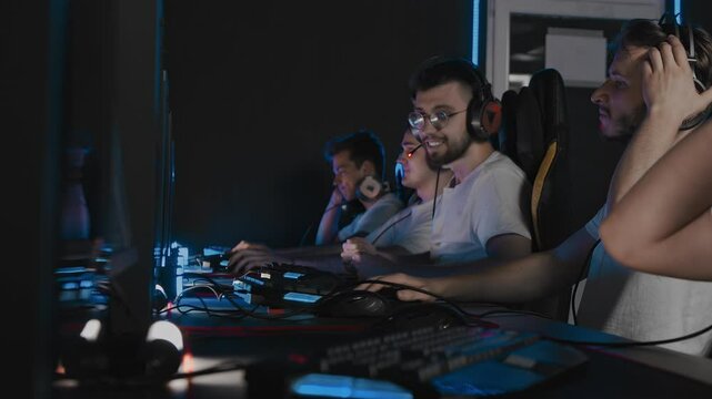 Players are defeated in round, map lose in cyber tournament, disappointment. Five gamers are using gaming mouse and keyboard while playing shooter game. E-sport players are playing real-time strategy