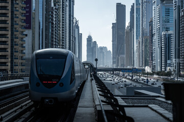 Modern train arriving at station in dubai's business bay district