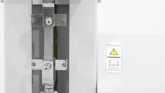 Close view of tensile testing of EVA plastic film for strength