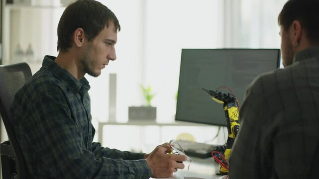 Dedicated software developers collaborate in cyberspace, focusing on robotics arm with data systems and innovative programming techniques.